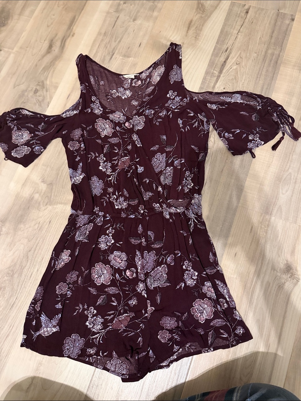 Size small maroon aeropostale floral romper with cutout detail on side